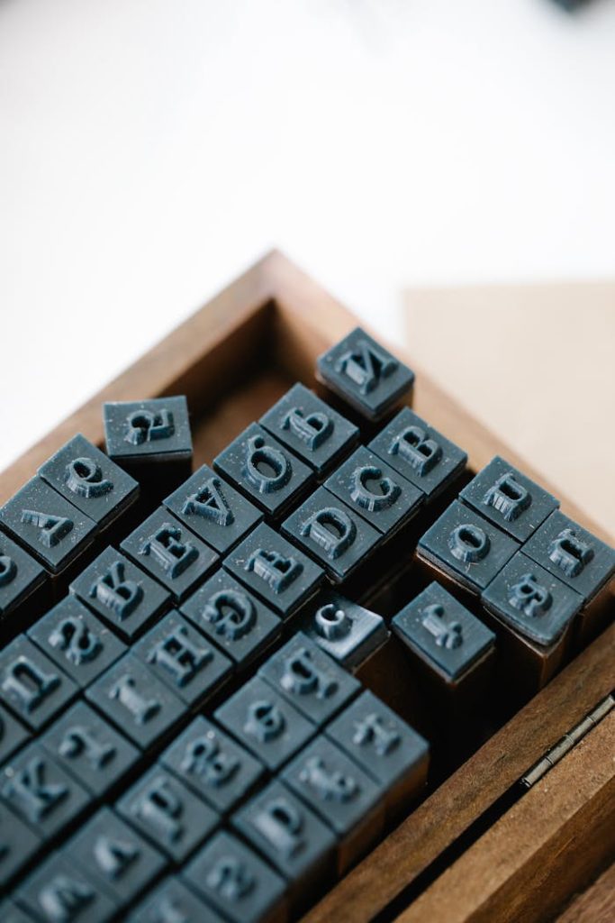 Close-up view of vintage letterpress stamps in a wooden box, perfect for crafting and design.