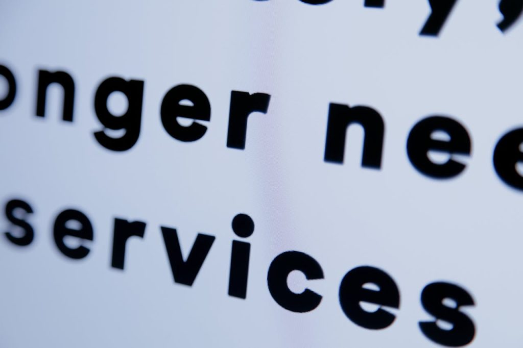 Close-up of black text on a white screen emphasizing services.